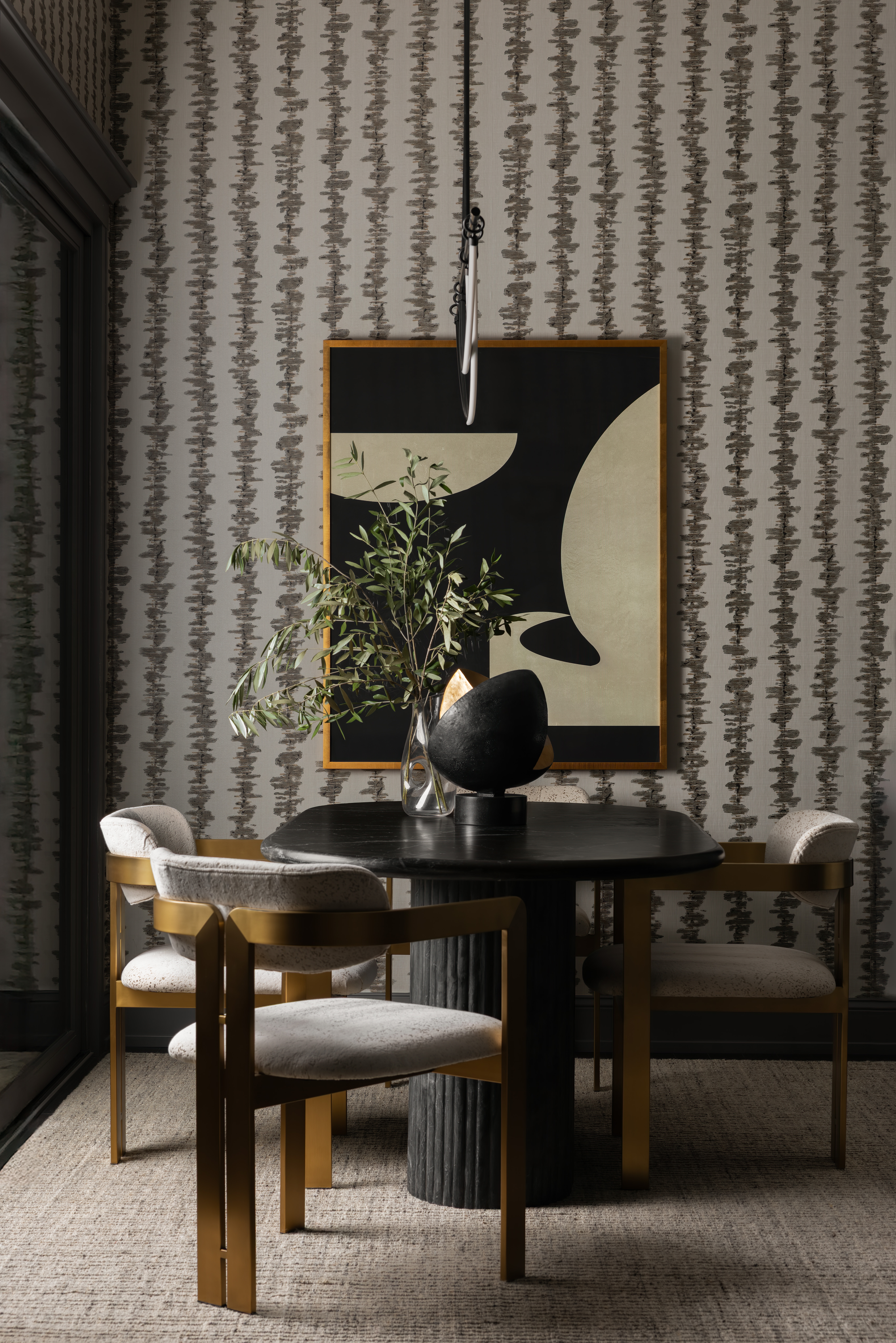 Contemporary Kansas City dining room featuring a round dark wood dining table with upholstered chairs, textured wallpaper, abstract artwork, and soft natural light from floor-to-ceiling windows.