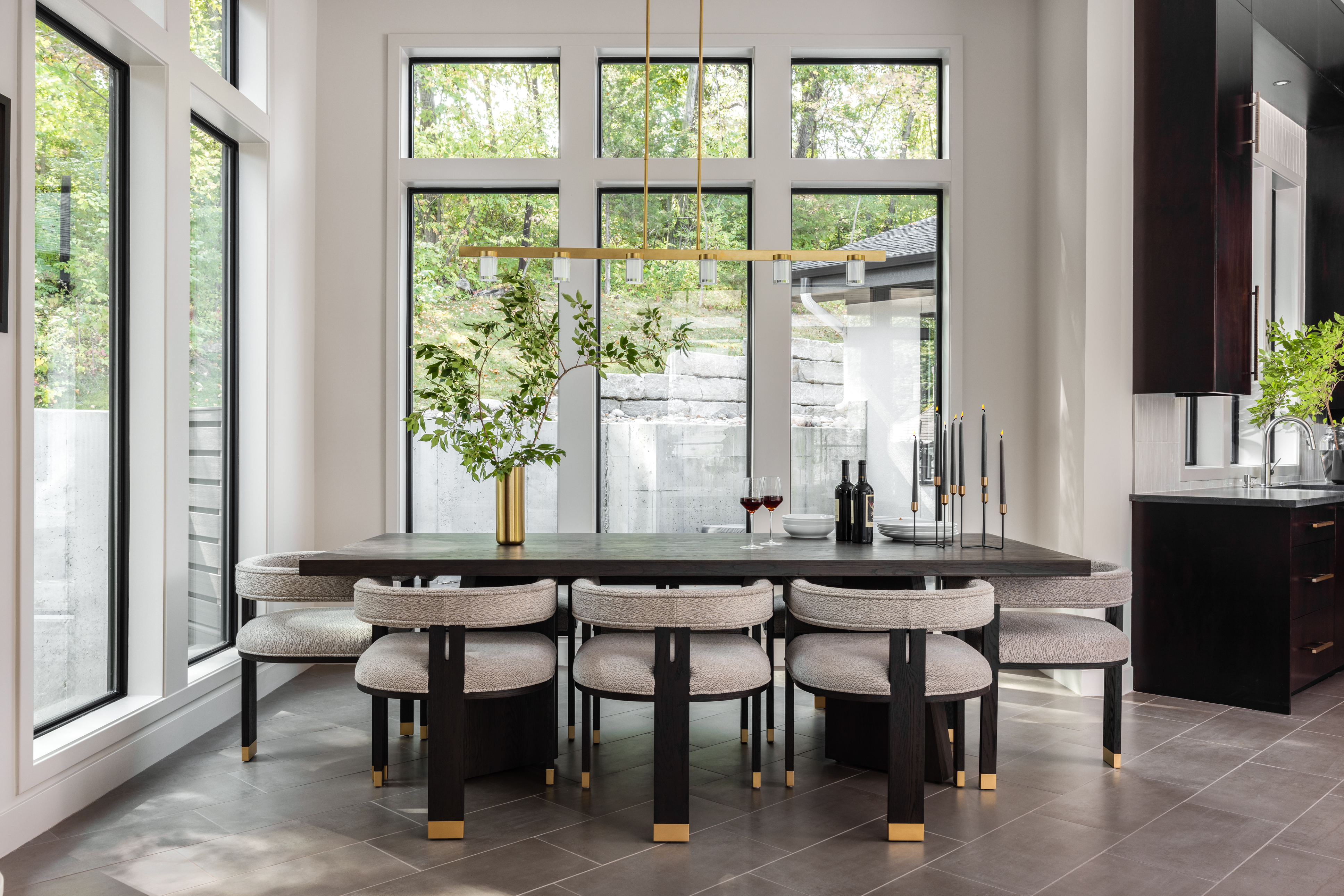 Luxury residential dining room featuring custom dining table, upholstered chairs, statement lighting, and refined interior design details.